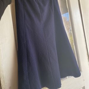 Blue and black lines just below knee skirt